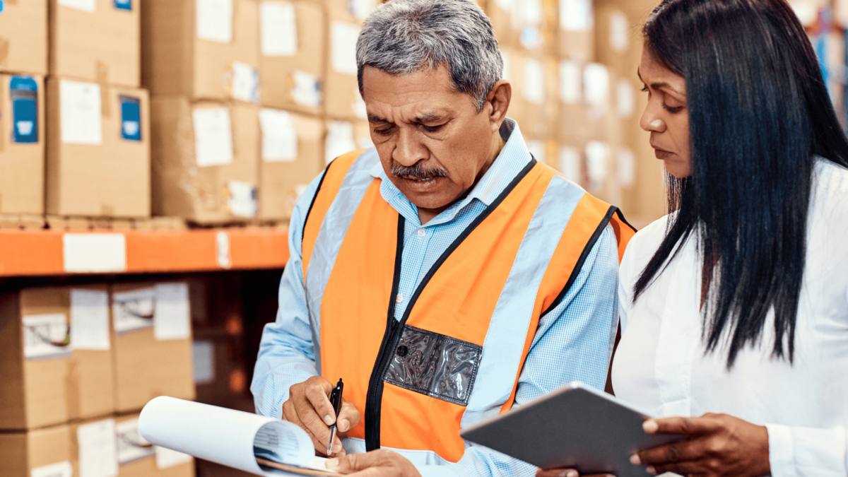 Man and woman checking warehouse inventory: "UPC Barcode Labels in Supply Chain Management"