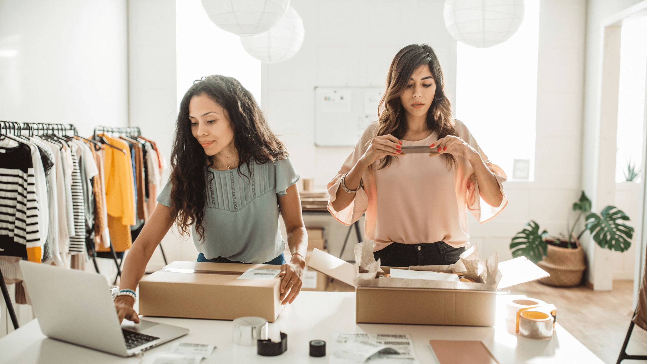 Women co-founders preparing labeled boxes for shipping, showcasing their business's GS1 certification for retail standards.