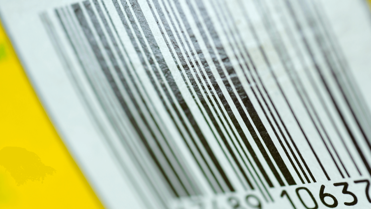 Detailed GS1 US barcode on a yellow background, showing a sequence of digits for product identification.