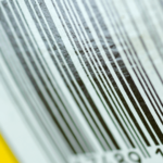 Detailed GS1 US barcode on a yellow background, showing a sequence of digits for product identification.