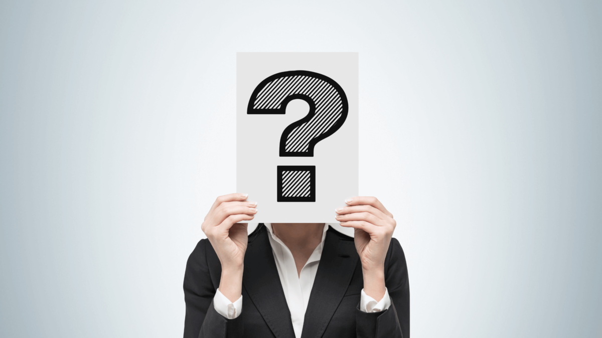 Businessperson with face covered by a question mark, symbolizing the uncertainty surrounding GTIN numbers