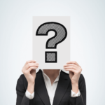 Businessperson with face covered by a question mark, symbolizing the uncertainty surrounding GTIN numbers