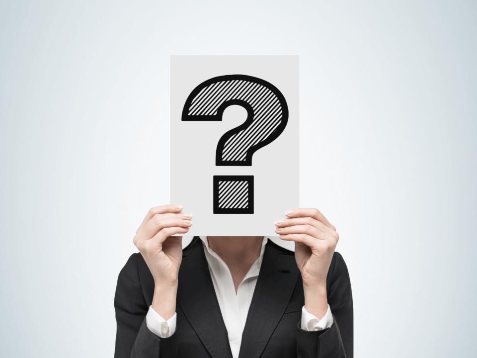 Businessperson with face covered by a question mark, symbolizing the uncertainty surrounding GTIN numbers