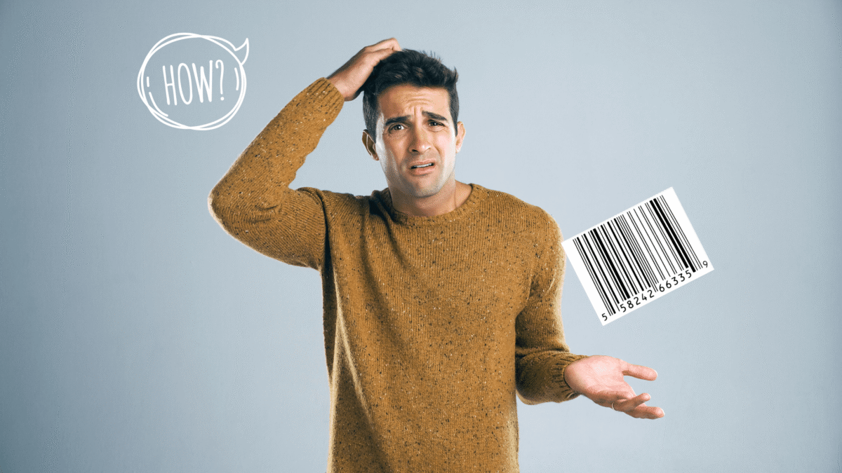 Young man scratching his head against a gray background with question mark bubble and single barcode label thinking - "how do I obtain a barcode for my product."